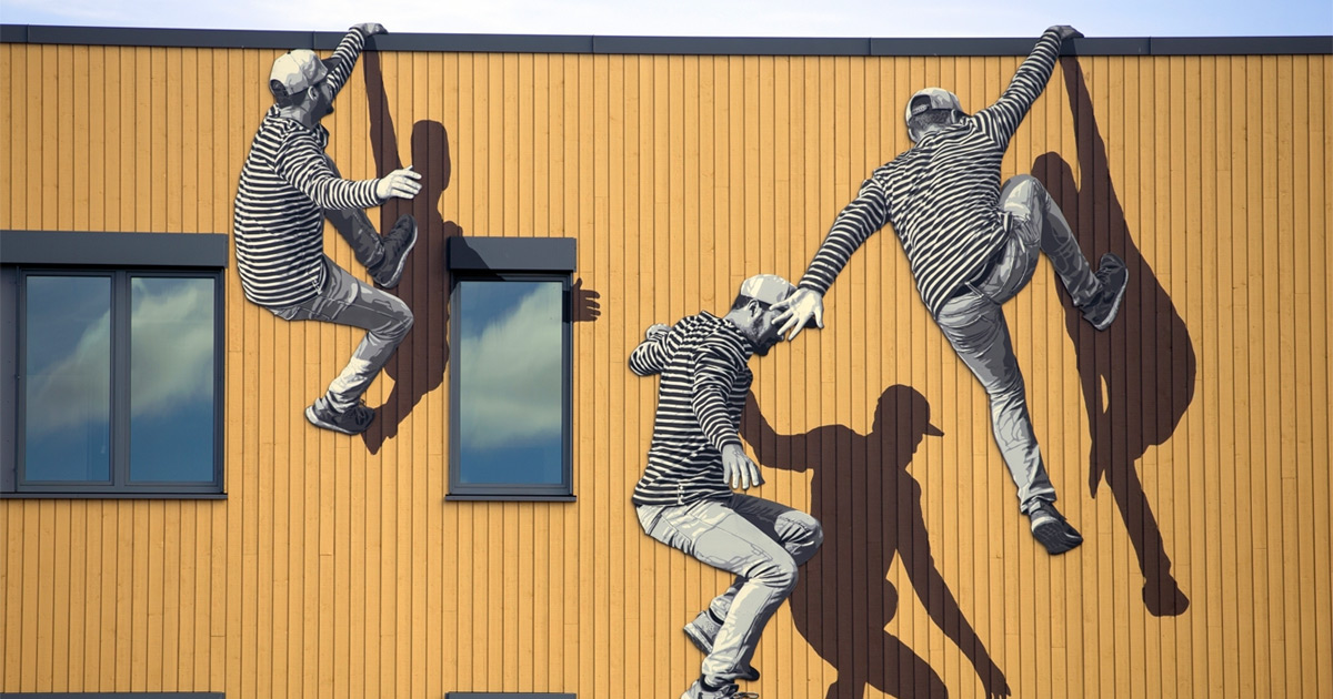 Figuras ágeis em preto e branco pulam e escalam paredes nesta arte de rua